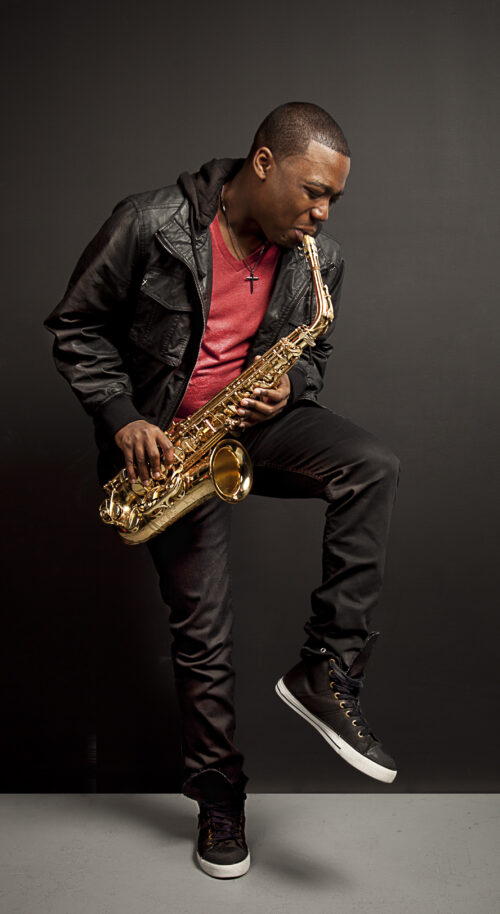 A man holding a saxophone in his hands.